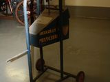 a small cart with a machine on it in a room
