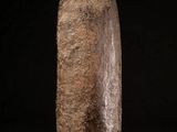 an image of a stone sculpture on a stand against a black background