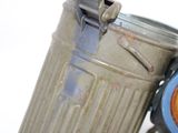 a close up of a trash can with a clock on top of it