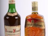 two bottles of liquor sitting next to each other on a white surface