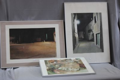 two framed pictures on a table next to a book