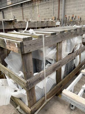 several pallets of wood are stacked on top of each other in a warehouse