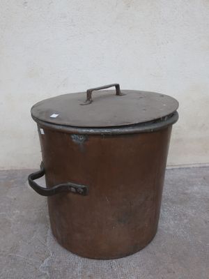 a large metal pot with a lid sitting on the floor