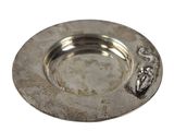 a silver plate with a design on it on a white background