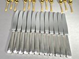 a lot of silver and gold forks and spoons