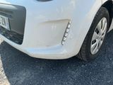 a white car that is parked on the side of the road