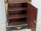 a small cabinet with a door open on the floor