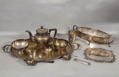 a silver plate with a teapot, spoon, and other items on it