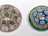 two glass buttons that are sitting on a white surface