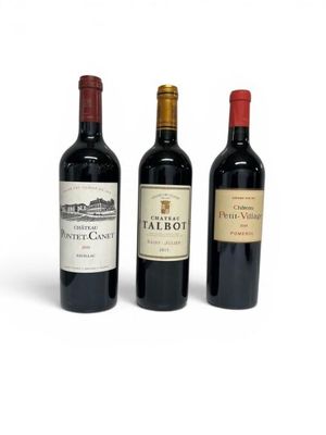 three bottles of wine are lined up on a white surface