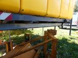 a large yellow boat sitting on the back of a truck