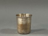 a silver cup that is sitting on a table