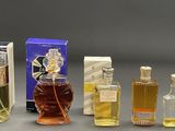 several bottles of perfume sitting next to each other on a table