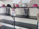 many shelves with hats on them in a room