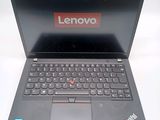 a black laptop with a red lenovo logo on the screen