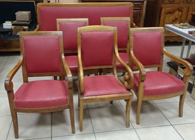 six red leather chairs are lined up in a room