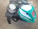 a green motorcycle with a helmet on the back of it