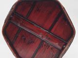 a small wooden box with a handle on a white surface