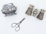 a pair of scissors next to a pair of silver objects