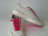 a pair of white sneakers with pink laces on them