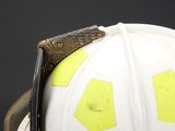 a white fireman ' s helmet with yellow stickers on it