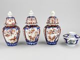 four pieces of blue and white vases sitting next to each other