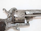 a close up of a gun on a white surface