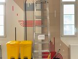 a picture of a room with a ladder and two bins
