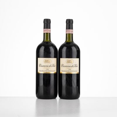 two bottles of red wine sitting on top of a table