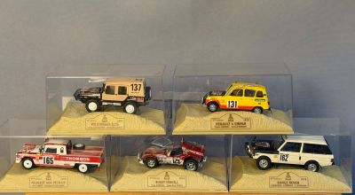 six petites voitures dans une vitrine posée sur une table