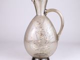 a glass pitcher with a floral design on it