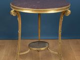 a gold and purple marble topped side table on a wooden floor