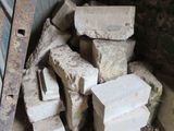a pile of bricks sitting on the ground next to a wall
