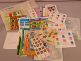 a pile of stamps and envelopes sitting on a table