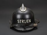 a black fire helmet with a silver horn on it