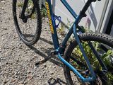 a blue bike that is leaning against a wall
