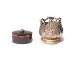 a silver vase and a wooden box on a white surface