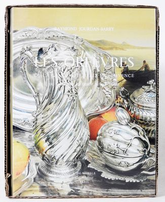 a book that has a picture of a silver vase on it