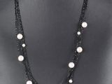 a close up of a mannequin with pearls on it