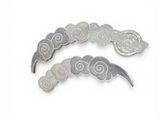 two pieces of silver and white brooches on a white surface