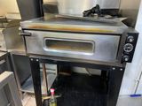 an oven that is sitting in the middle of a kitchen