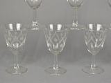 six wine glasses are lined up in a row on a table