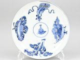 a blue and white plate with flowers and leaves on it