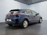the rear end of a blue car in a large room