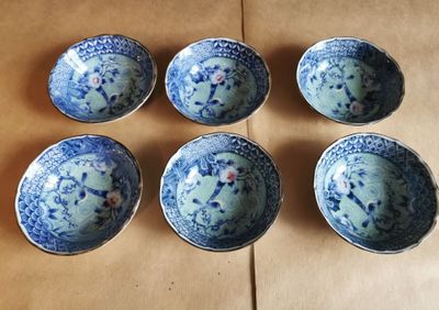 six bols bleus et blancs posés sur une table en bois