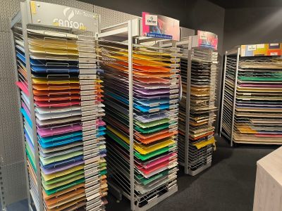 a lot of folders on the shelves in the store