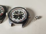 two watches sitting next to each other on a table