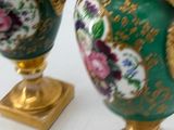 two vases that are sitting on a table