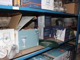 shelves filled with boxes of wine glasses and other items in a room