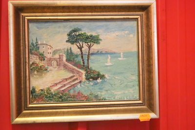 a picture of a painting hanging on a red wall